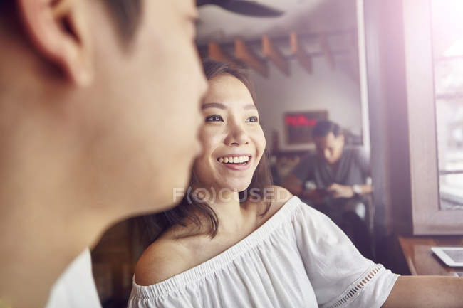 Happy young asian couple together in bar — Stock Photo