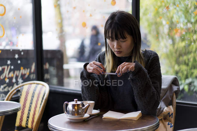 Joven atractivo casual asiático mujer tomando foto de notas - foto de stock