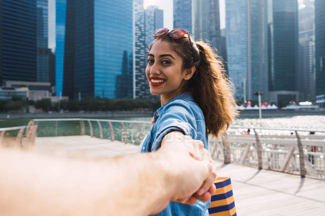 Young beautiful asian woman holding hands with man — Stock Photo