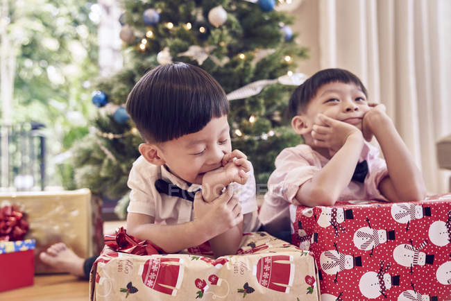 Felice famiglia asiatica che celebra il Natale insieme, ragazzi con regali vicino abete — Foto stock