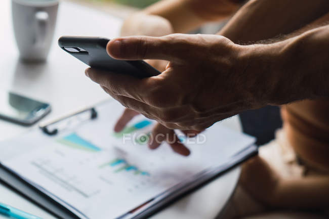 Cropped image of business man using mobile phone — Stock Photo