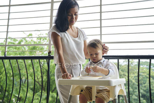 Mother bonding with her son at the balcony — Stock Photo