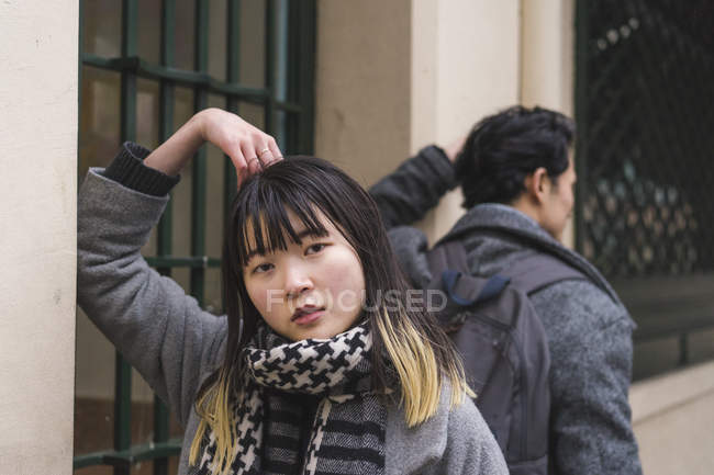 Young attractive casual asian couple on city street — Stock Photo