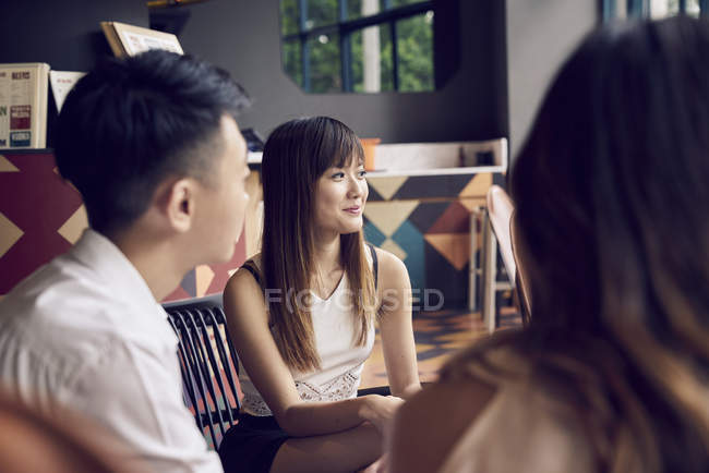 Company of young asian friends together sitting in cafe — Stock Photo