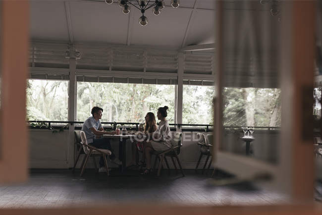 Gruppe von Freunden sitzt am Tisch im Restaurant — Stockfoto