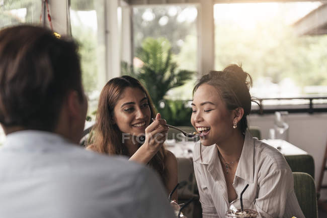Group of friends at a restaurant, having meal — Stock Photo