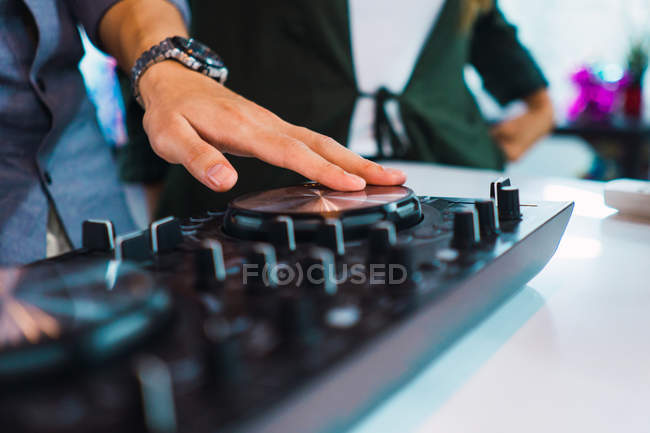 Cropped image of man using dj device in modern office — Stock Photo