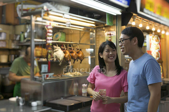 RELEASES Happy asian couple looking out in cafe at chinatown — Stock Photo