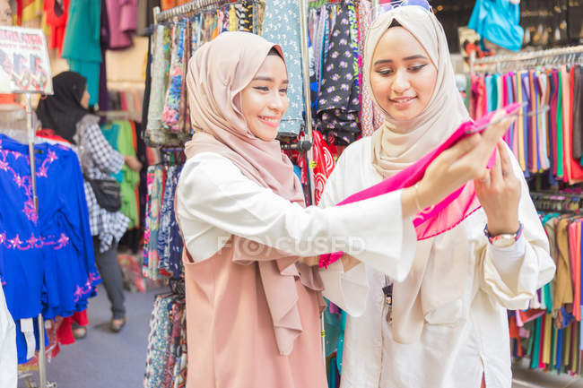 Two muslim girls in fabrics shop — Stock Photo