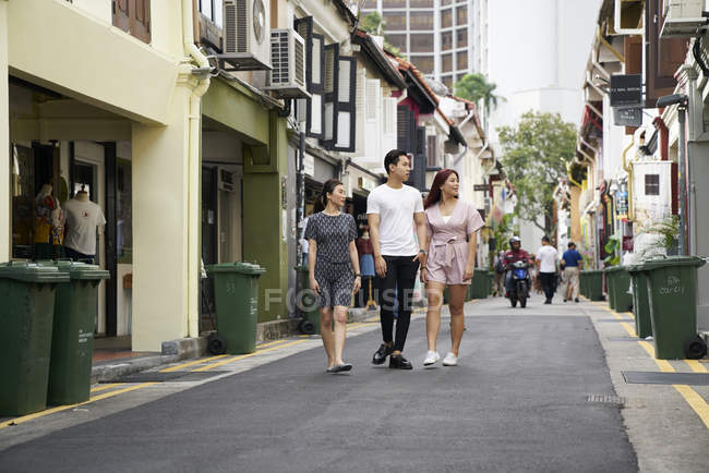 Young asian people walking on city street — Stock Photo