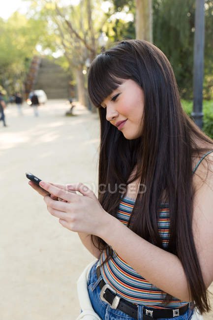 Eurasian woman using smartphone on the streets of barcelona — Stock Photo