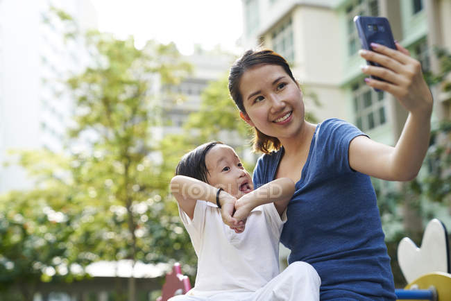 Jovem mãe tirando uma selfie com seu filho — Fotografia de Stock