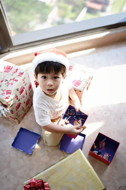 Happy asian boy looking up in camera at Christmas at home — Stock Photo