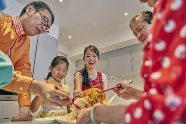 RELEASES Happy asian family eating together at table at chinese new year — Stock Photo