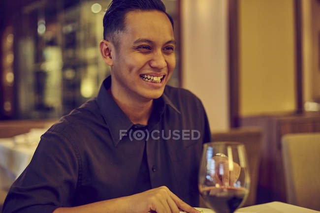 Joven asiático guapo hombre en café con vino - foto de stock