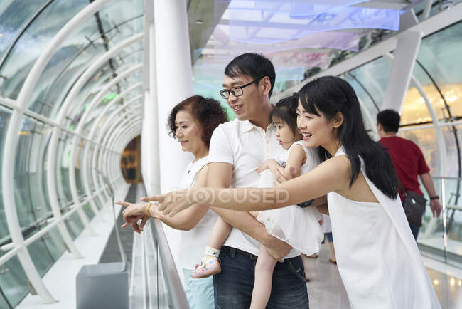 RELEASES Happy asian family spending time together and pointing — Stock Photo
