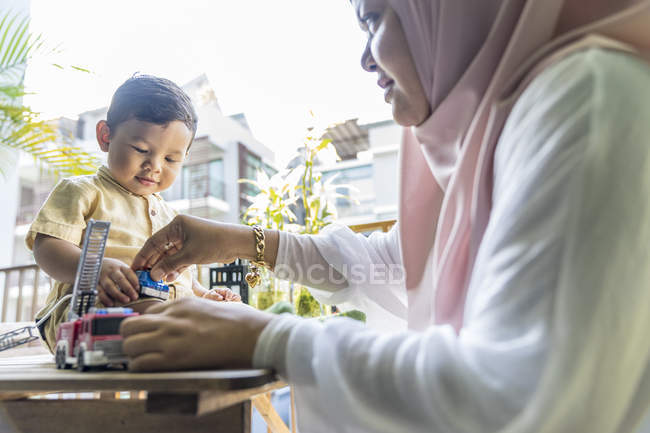 Grandmother playing with her grandson at home — Stock Photo