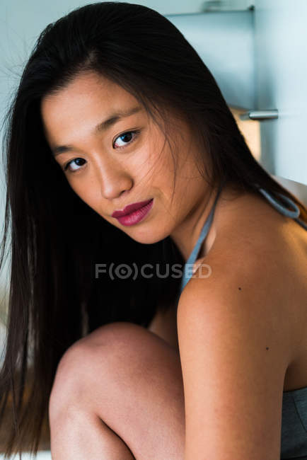 Young Chinese woman looking at camera — Stock Photo