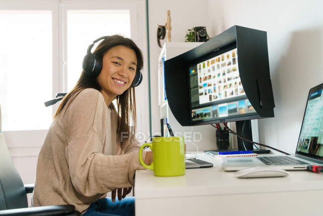 Chinese woman with headphone looking at the camera — Stock Photo