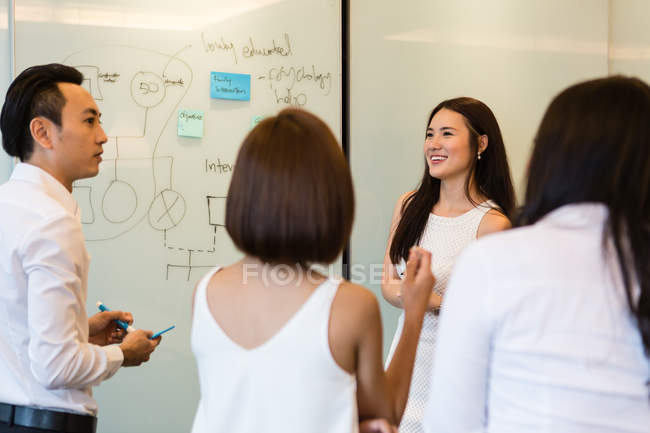 Young asian people working together in modern office — Stock Photo