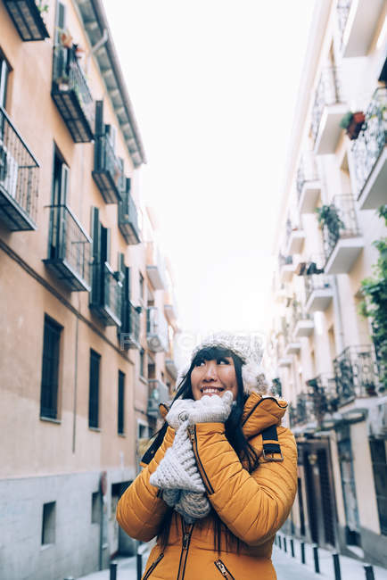 Young attractive asian woman posing to camera on street — Stock Photo