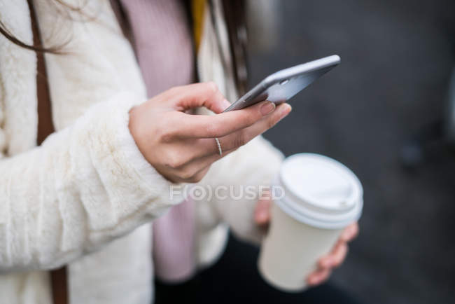 Cropped image of Young Chinese woman on mobile phone — Stock Photo