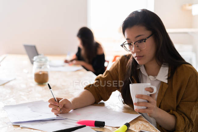 Young Chinese women working in modern office — Stock Photo