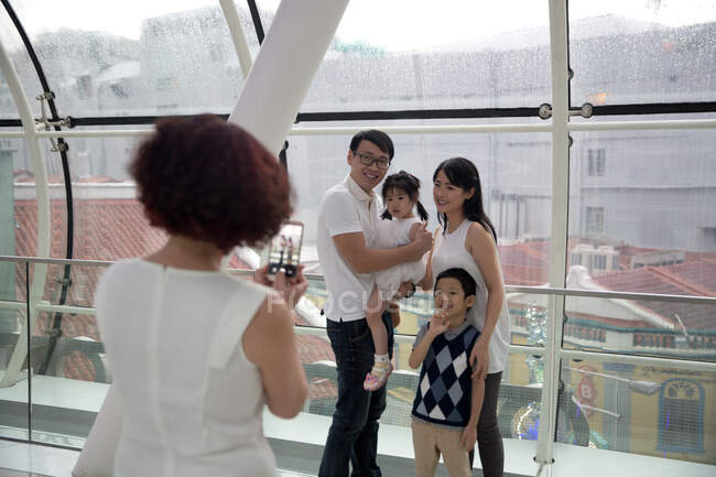 A grandmother takes a photo of her family while out shopping — Stock Photo
