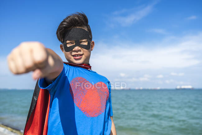 Superhero kid doing the punch pose towards camera. — Stock Photo