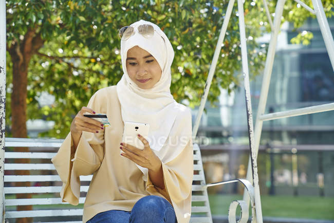 Женщина в хиджабе делает покупки в Интернете — стоковое фото