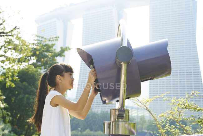 Young girl exploring Gardens by the Bay with an electronic Binoculars — Stock Photo