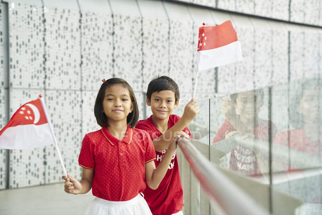 Frères et soeurs célébrant singapores fête nationale — Photo de stock