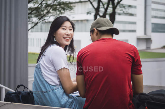 Young asian college students studying outdoors — Stock Photo