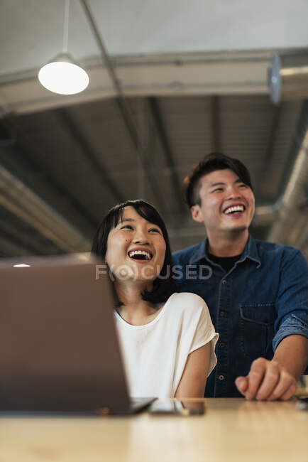 Asian couple at work — Stock Photo