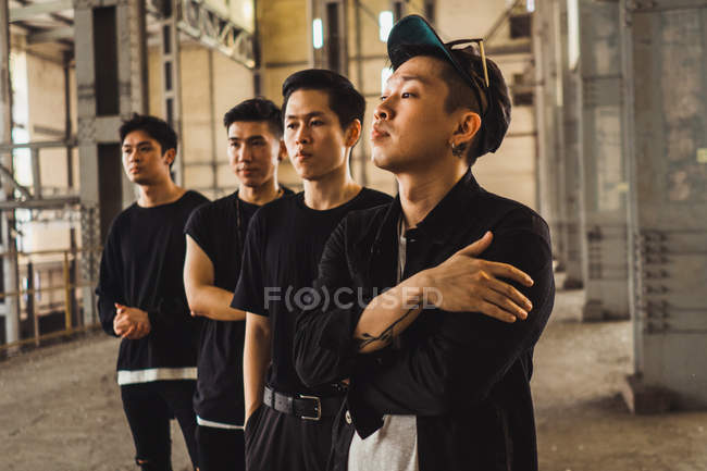 Young asian rock band posing together for camera — Stock Photo