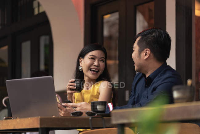 Happy asian young couple together in cafe — Stock Photo