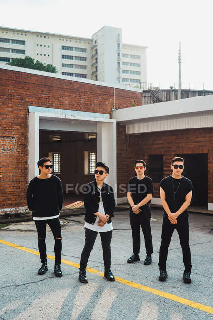 Young asian rock band posing together for camera — Stock Photo