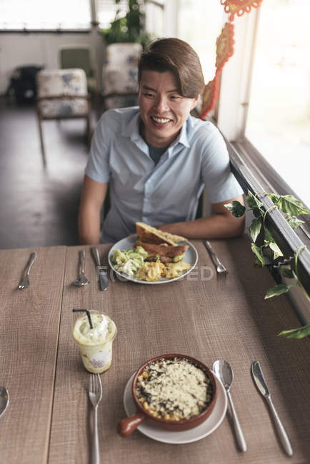 Portrait of young handsome asian man in restaurant — Stock Photo