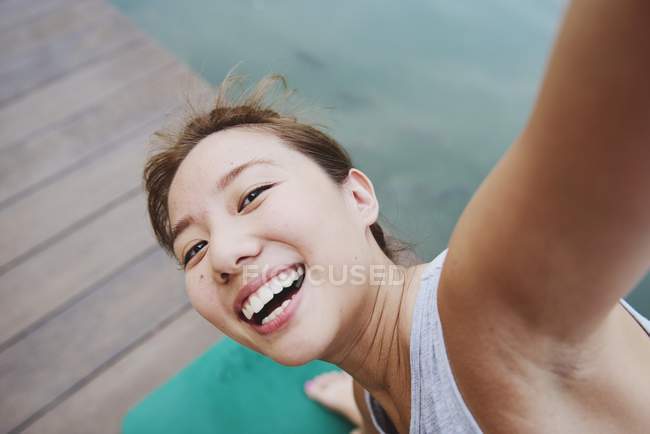 Young asian sporty woman making yoga — Stock Photo