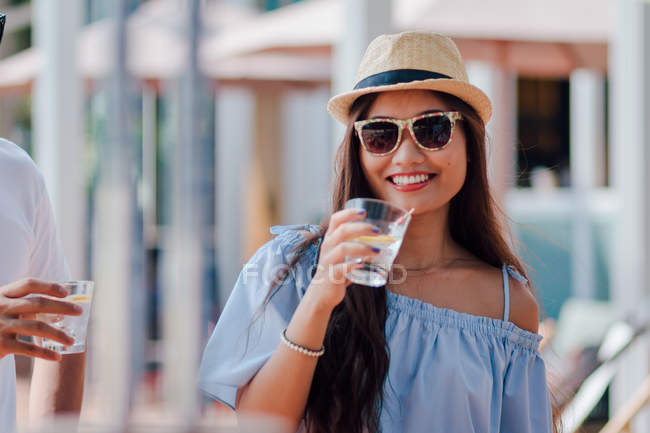 Attractive young asian woman having drink — Stock Photo