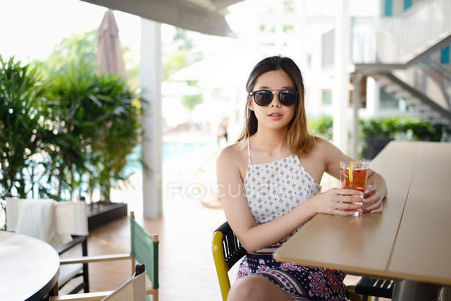 Portrait of young attractive asian woman with hot drink — Stock Photo
