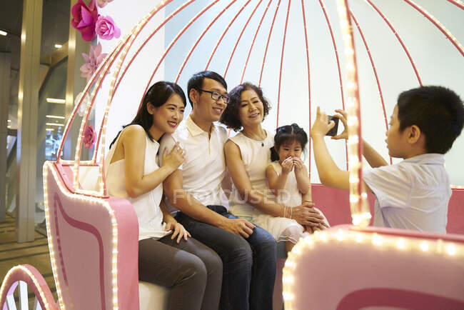 Happy young asian family taking photo together — Stock Photo