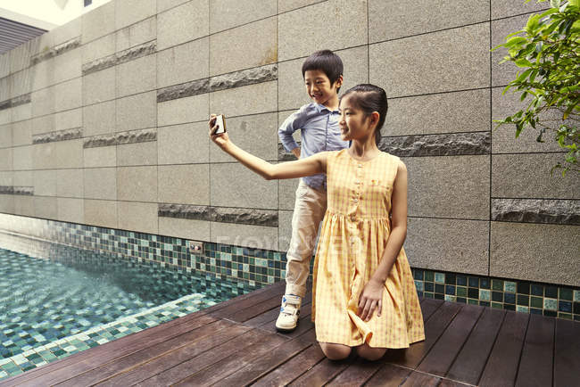 Two cute brother and sister together taking selfie — Stock Photo