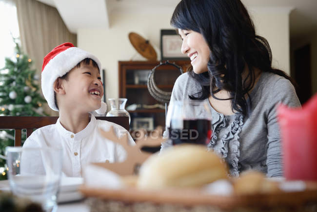 Happy asian mother and son celebrating Christmas together at home — Stock Photo