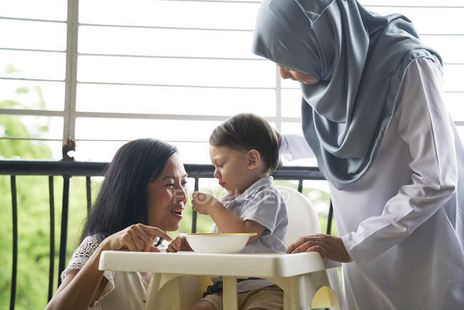 Grandmother and mother bonding with the baby at the balcony — Stock Photo