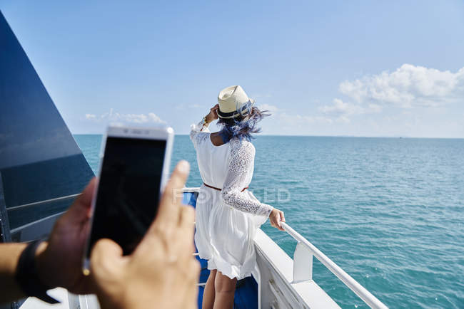 Man taking photo of young woman on the way to Koh Kood Island, Thailand — Stock Photo