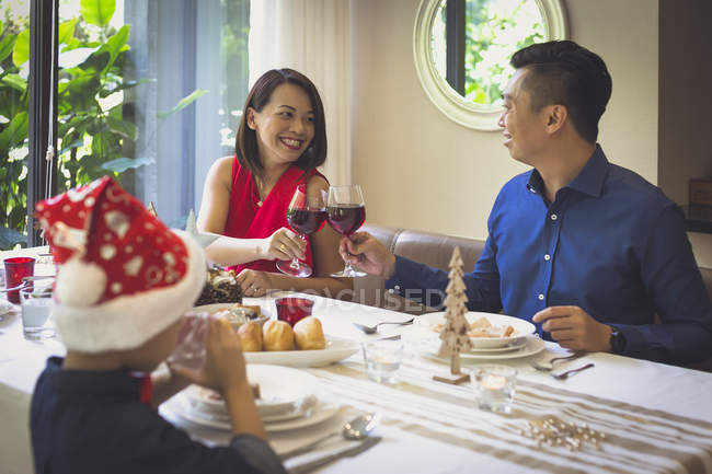 Singaporean family enjoying a festive dinner in beautiful house during Christmas holiday — Stock Photo