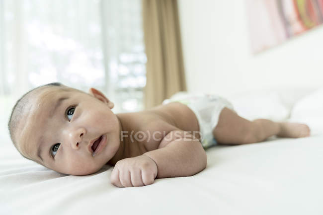 Baby lying down on his tummy at home — Stock Photo