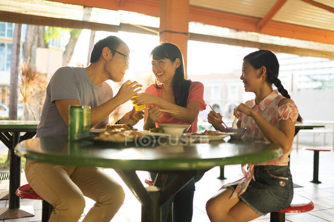 Young asian family together at cafe — Stock Photo