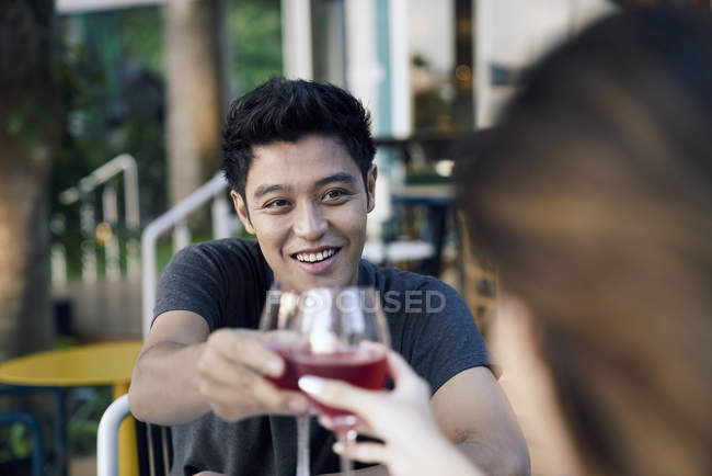 Asian couple having date in cafe with wine — Stock Photo